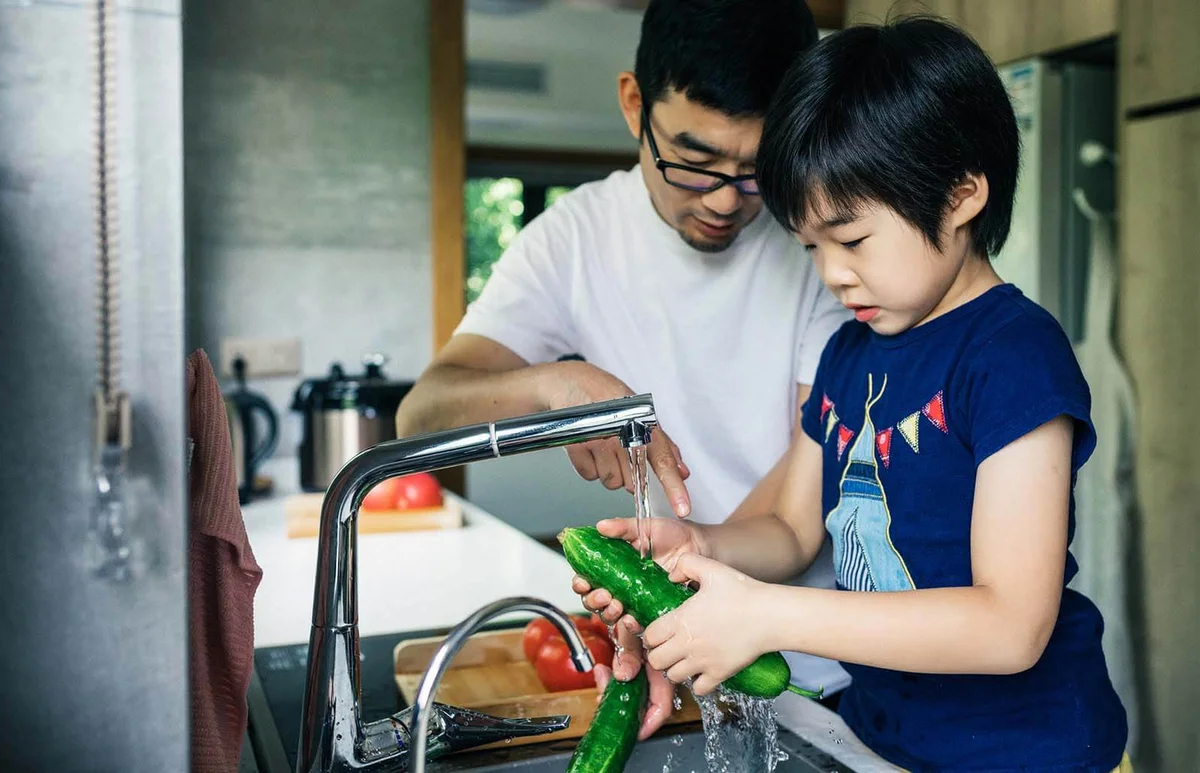 Father and son washing Fresh fruit