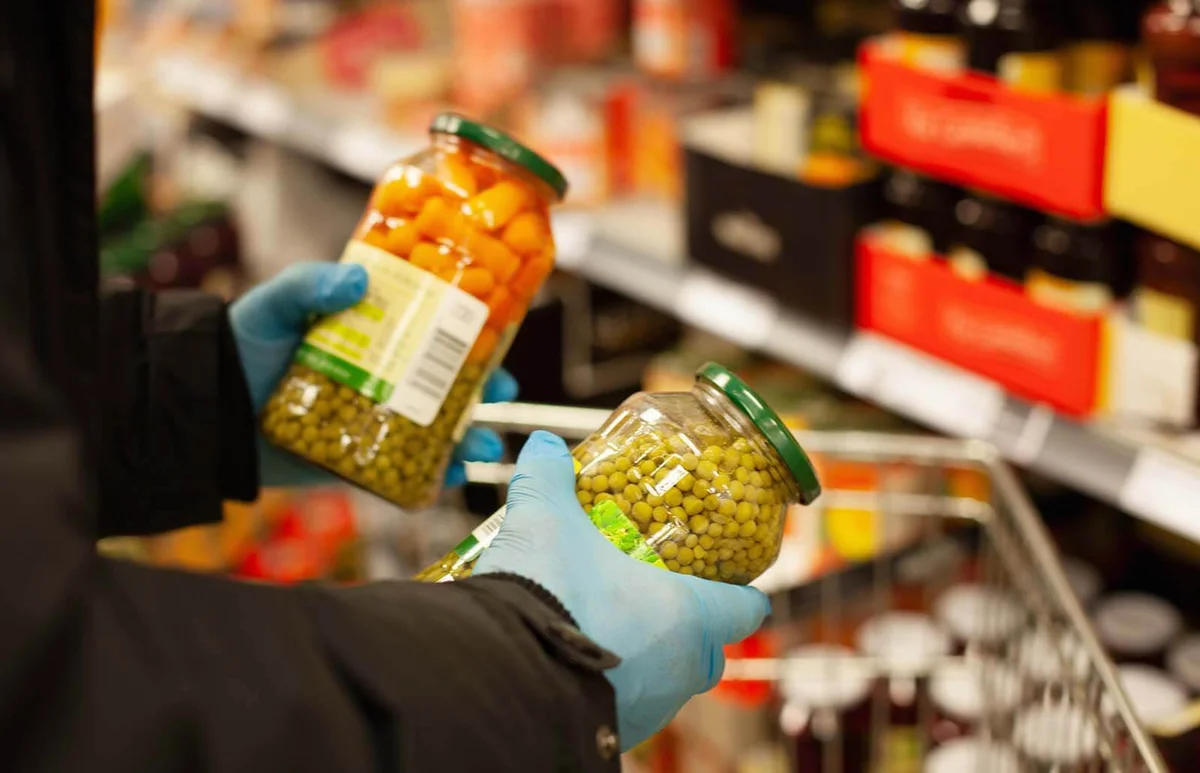 Man shopping for preserved vegetables at supermarket