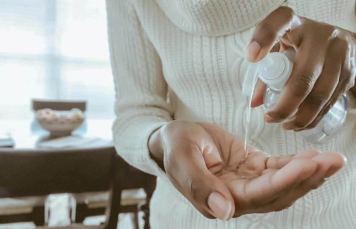 Woman Uses Hand Sanitizer
