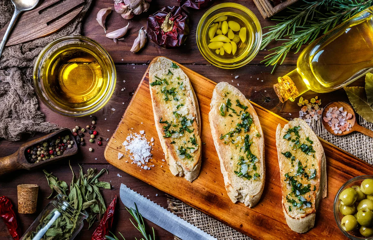 garlic basil and olive oil bruschetta on table in a rustic kitchen