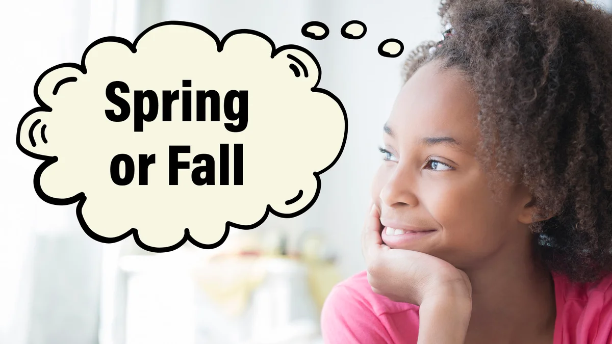 Girl looking out window thinking about spring or fall