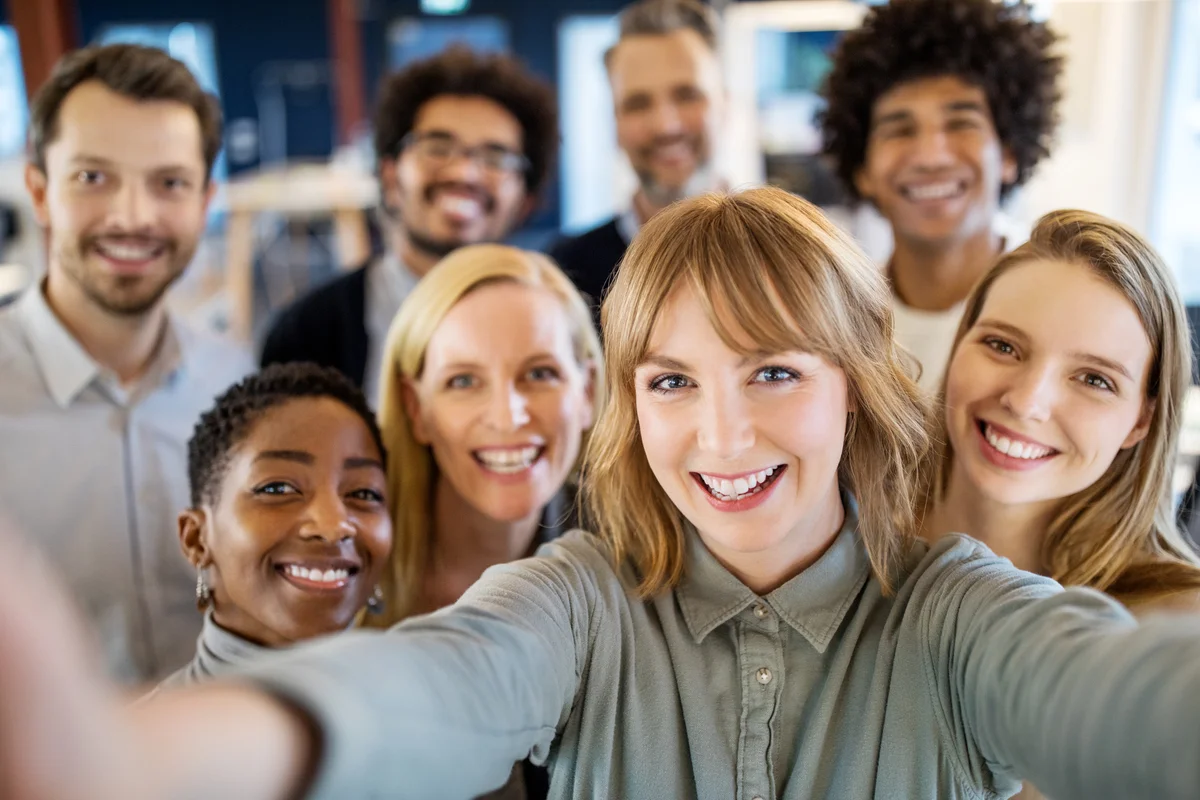 Smiling workers take selfie