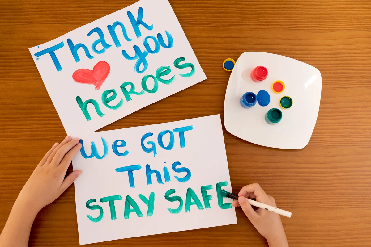 Child writing positive messages to frontline heroes working during Coronavirus (COVID-19) quarantine