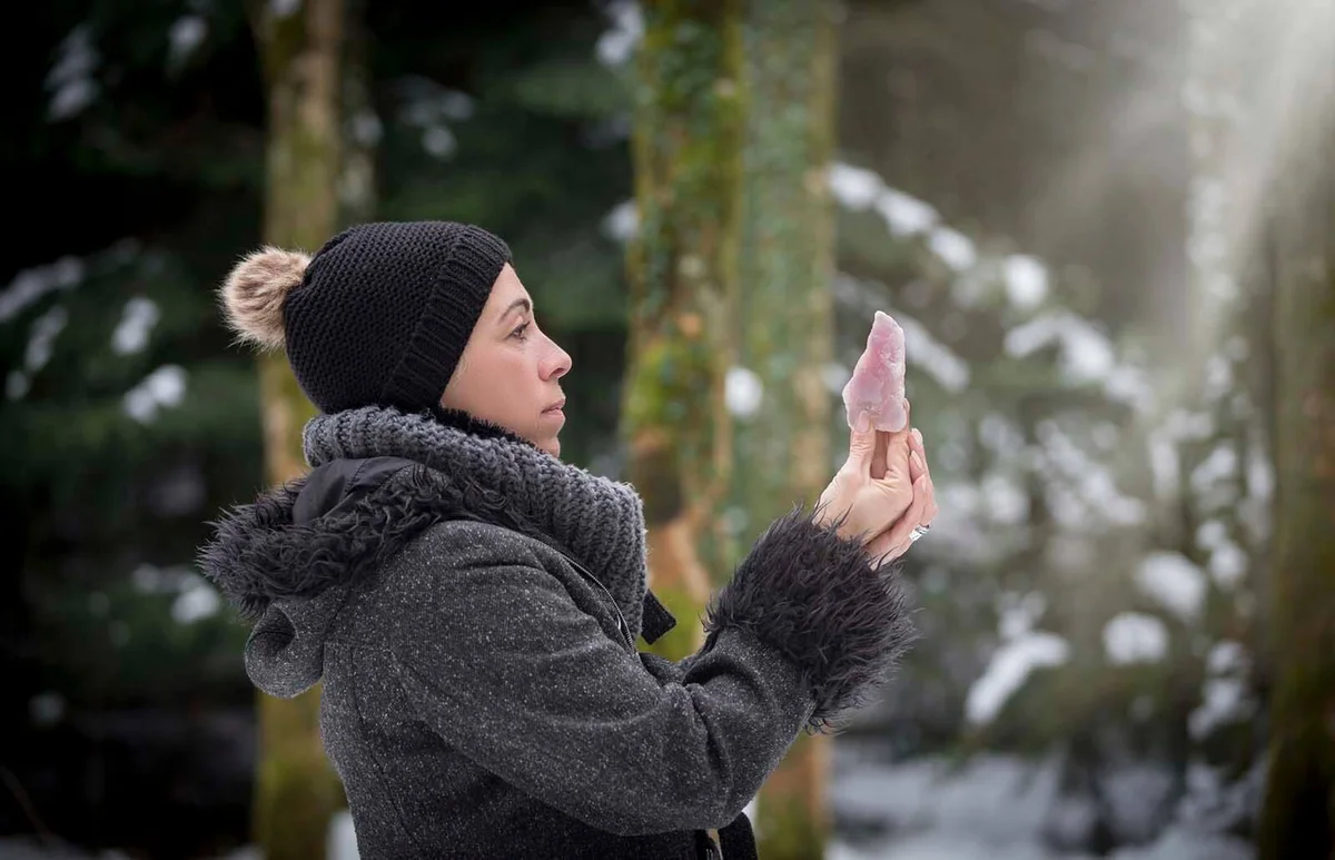 woman is holding a rose quartz