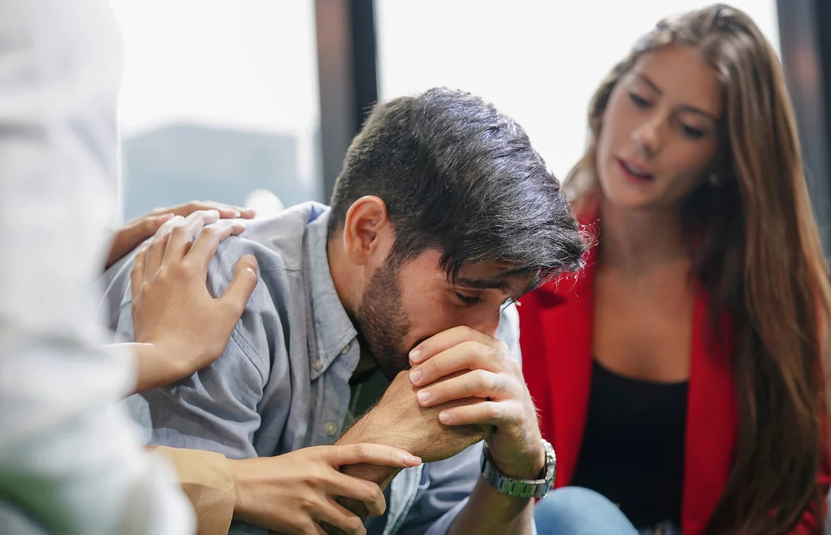 Friends consoling and care a person in the group