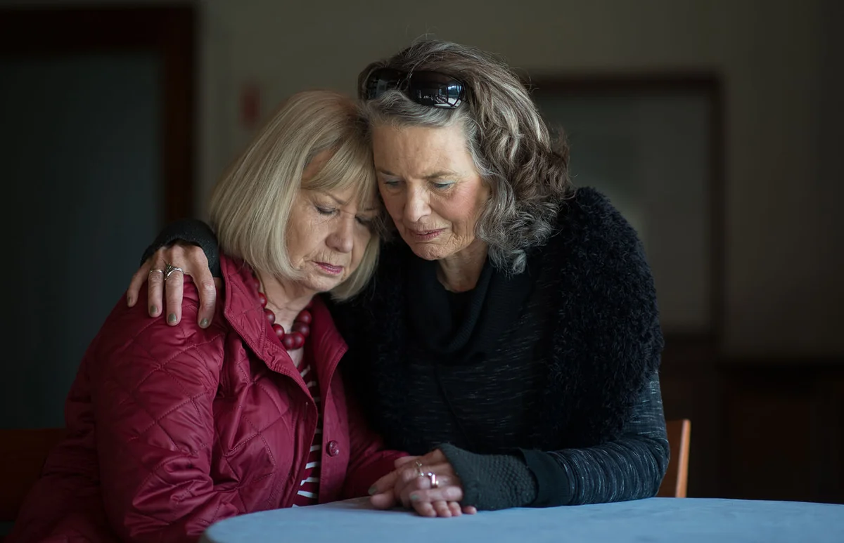 Two senior ladies supporting one another