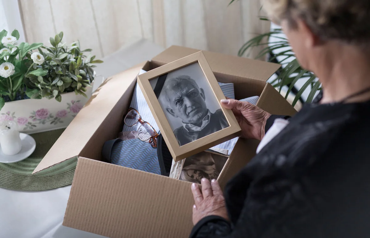 Woman is packing things of her dead husband