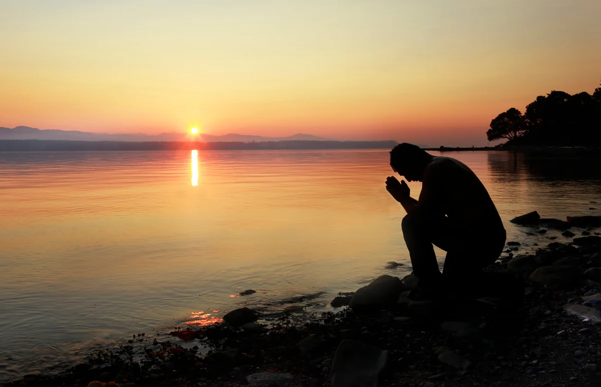 A man meditating outside