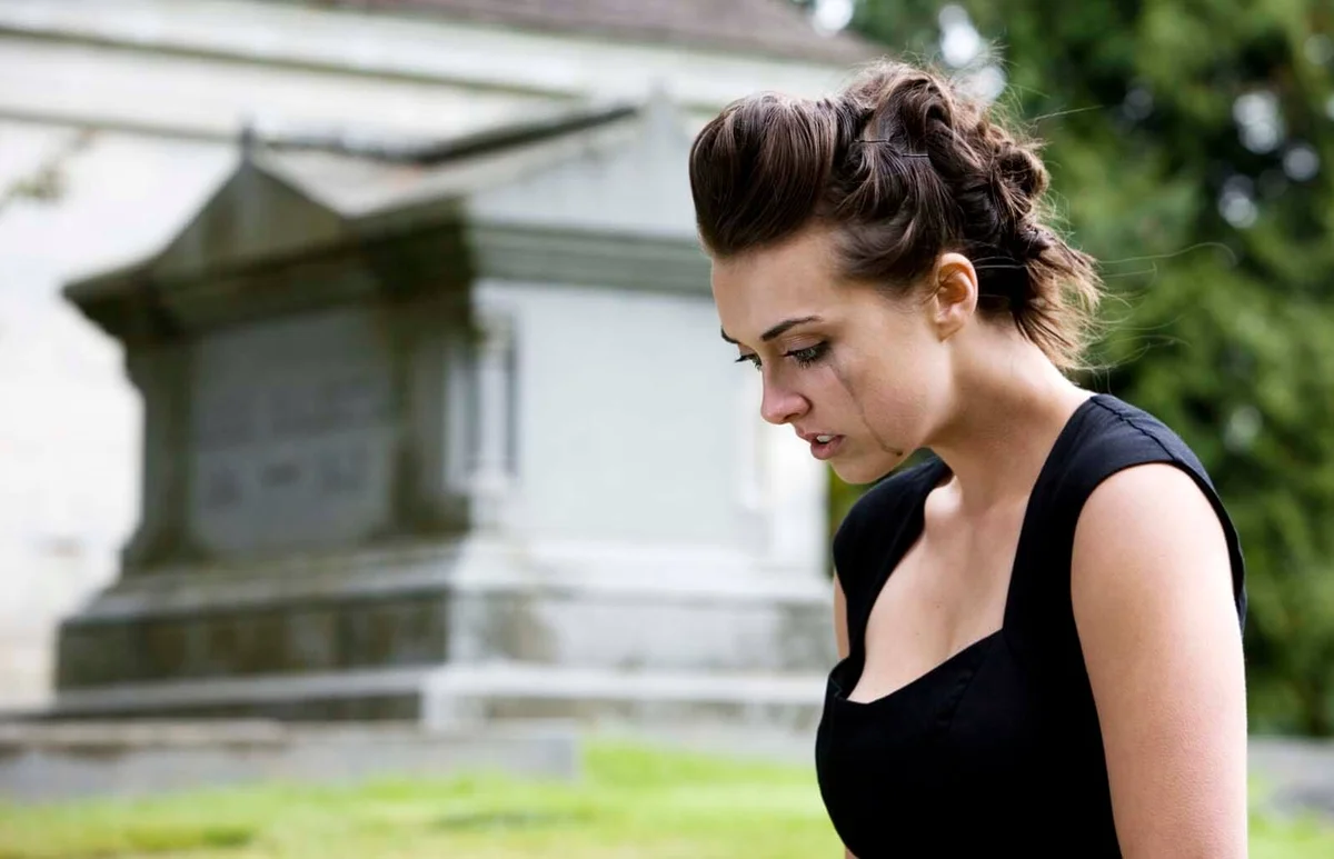 Brunette Young Woman Mourning at Graveyard