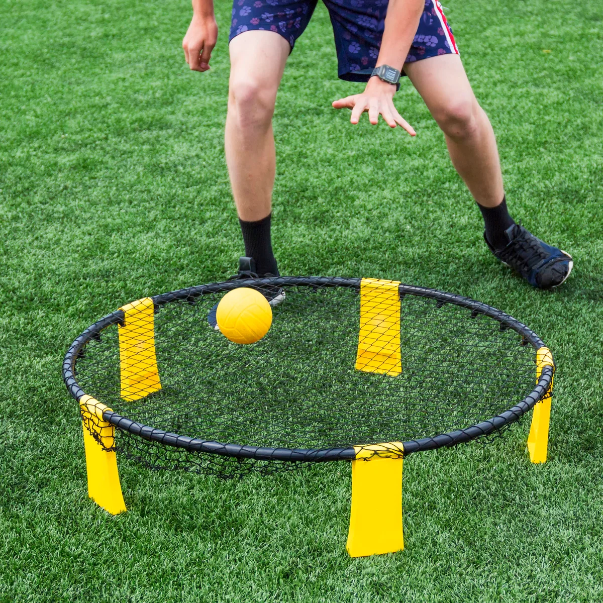 Playing spike ball on green turf