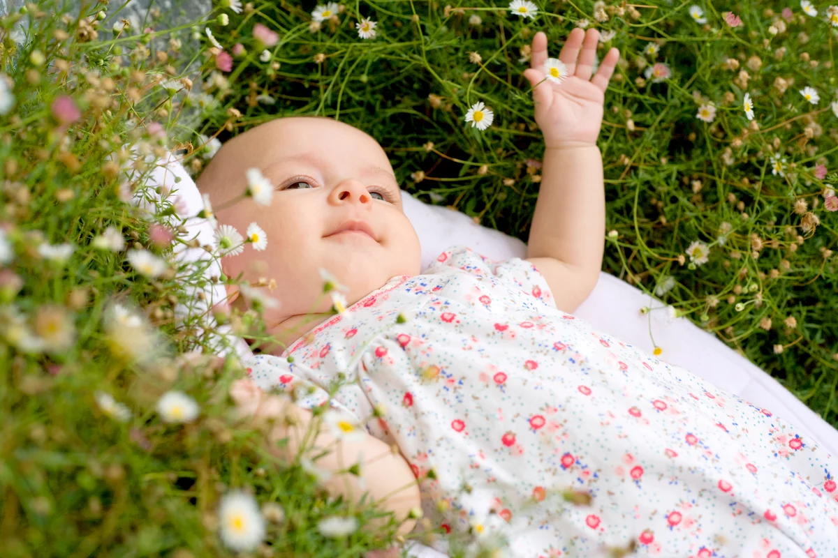 Baby lying among flowers