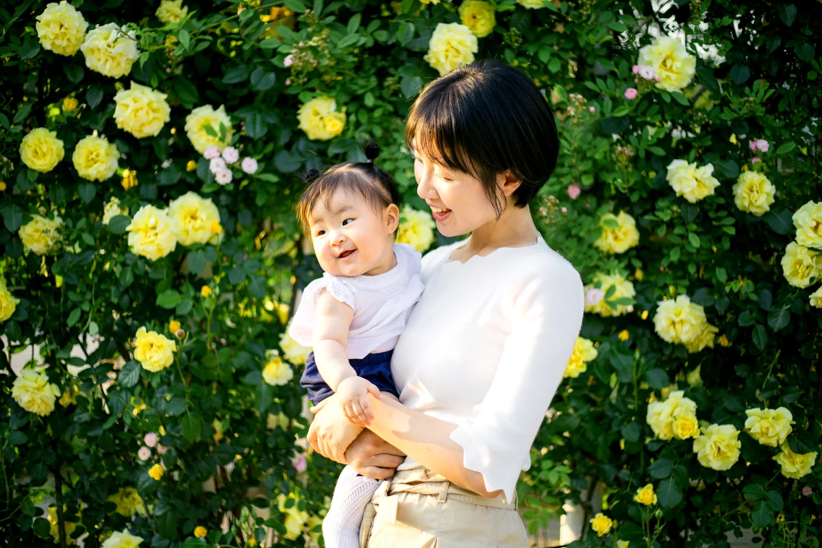 Happy Mother playing with daughter in park
