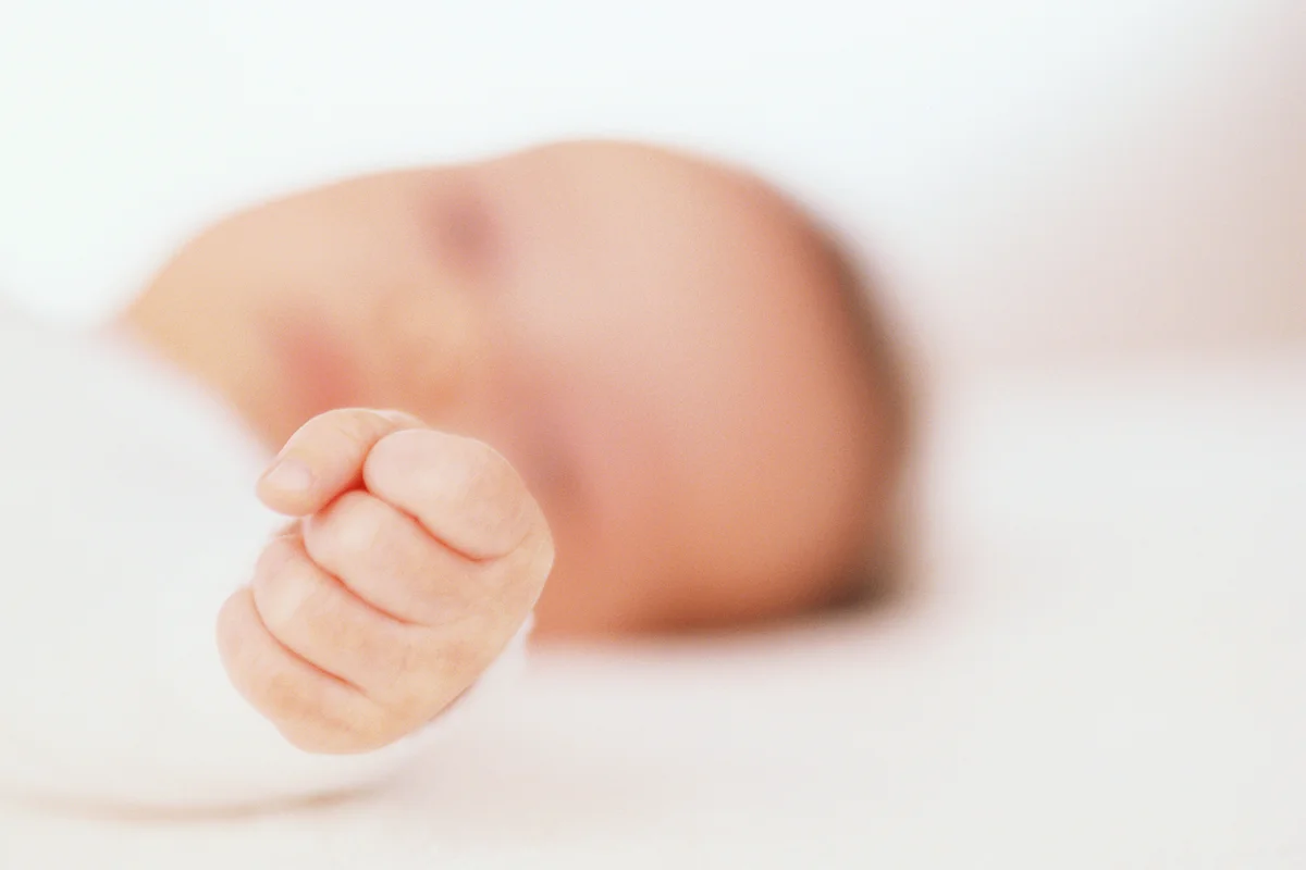 Baby girl with clenched hand