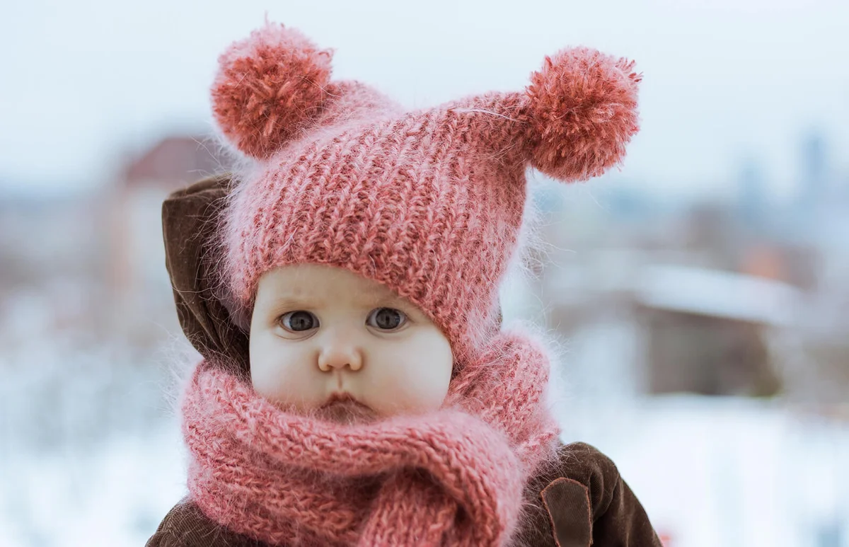 Little Girl Wearing a Pink Knitted Hat and Scarf