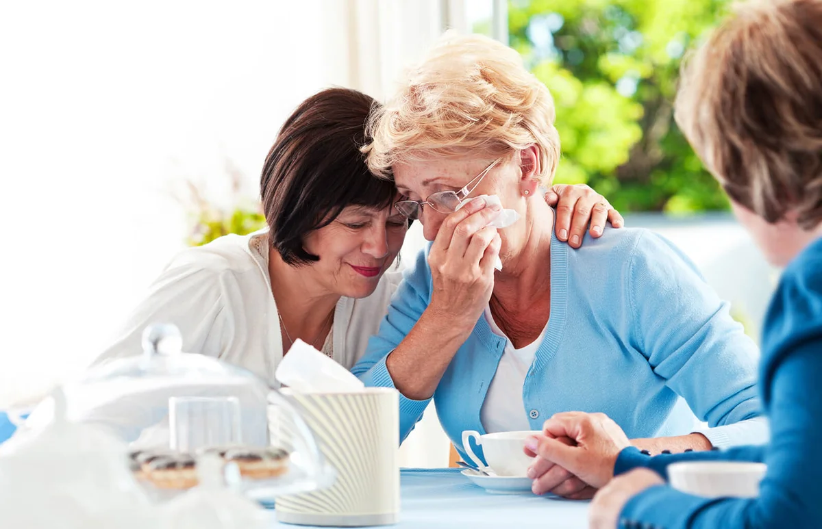Senior women consoling their friend