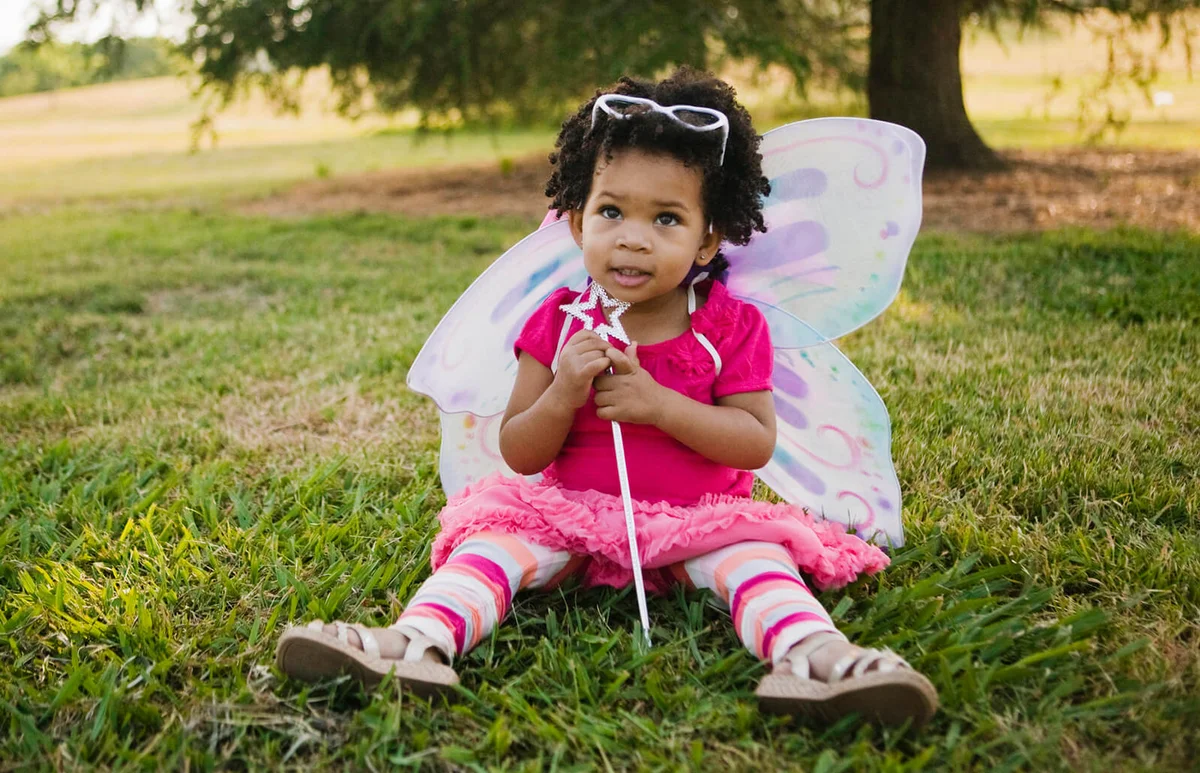 baby girl in fairy costume in park