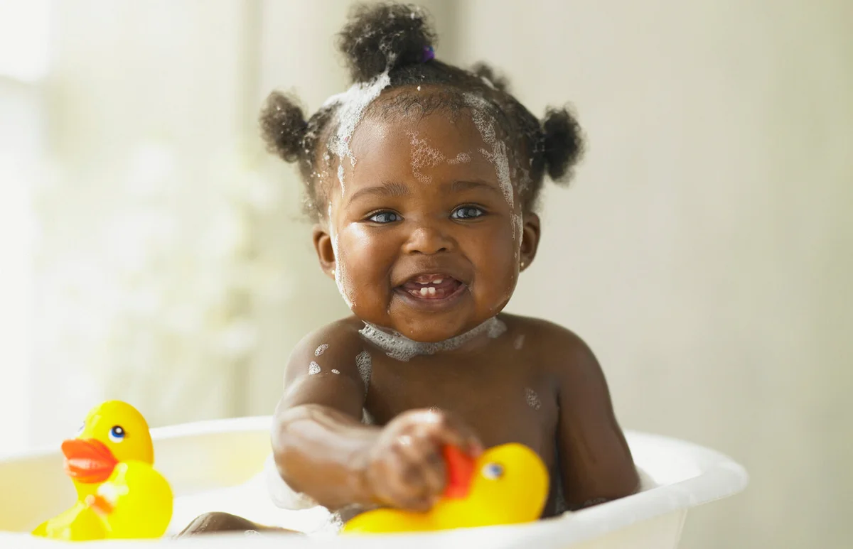 Baby girl playing in the bathtub