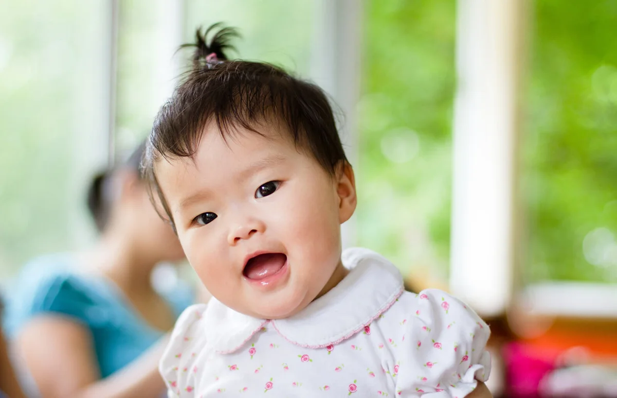 Cute happy baby girl with mouth open