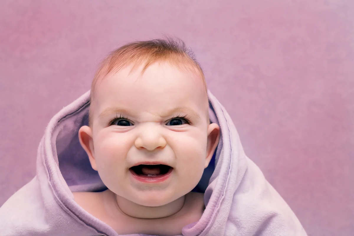 Baby in a towel with an evil smile