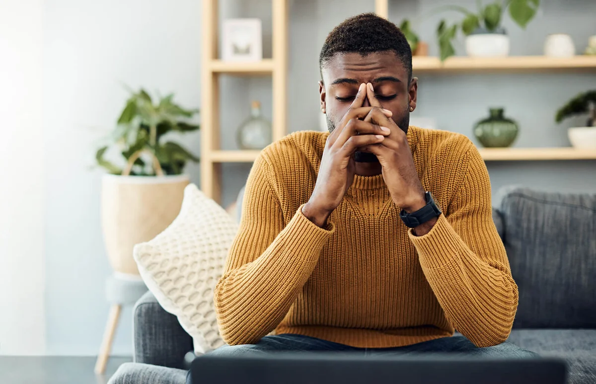 young man looking stressed out at home