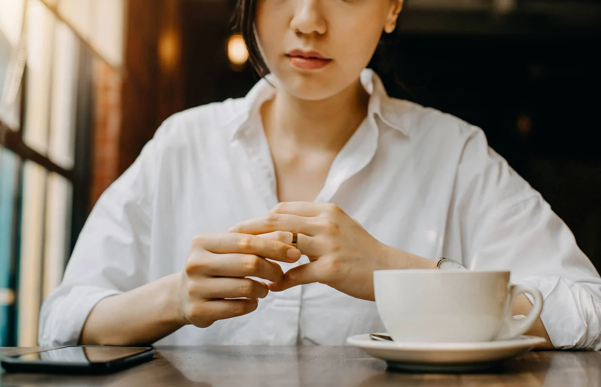 Woman touching the wedding ring on her finger