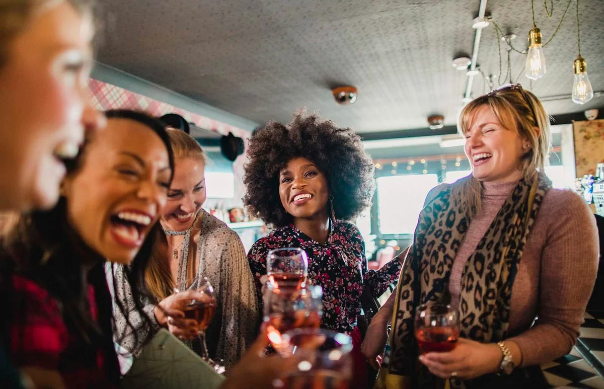 women enjoying a celebratory toast together in a bar