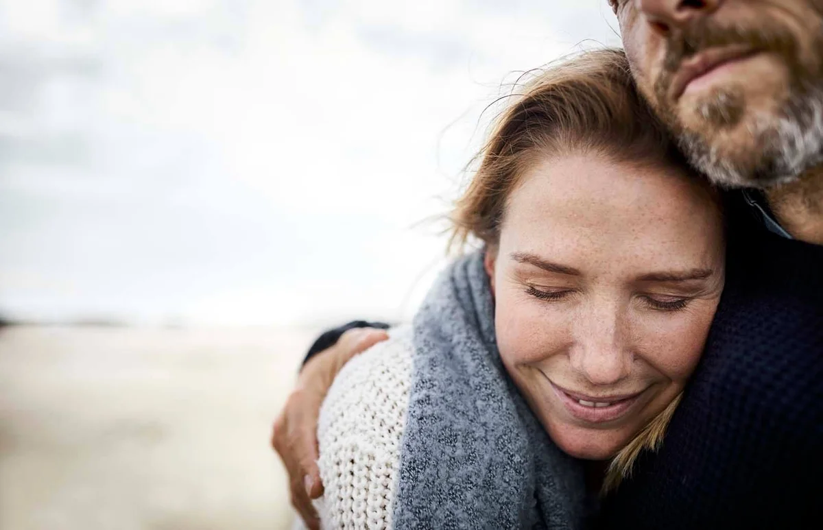 Affectionate couple hugging on the beach