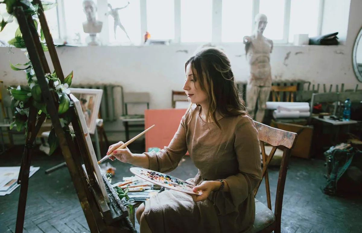 Caucasian woman painting on canvas
