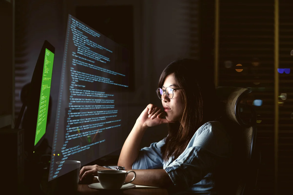 Woman coding at night