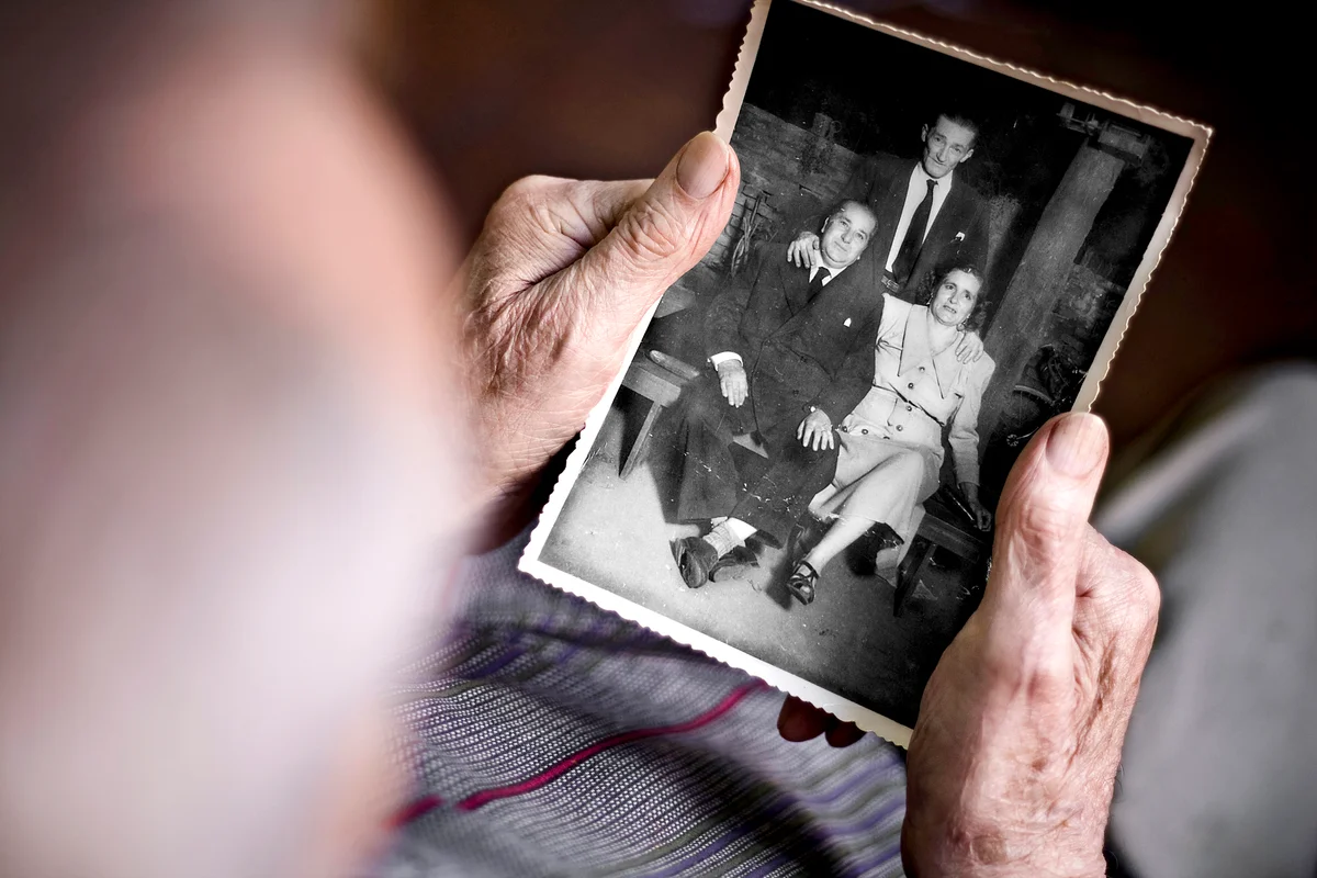 Old man looking at a photograph