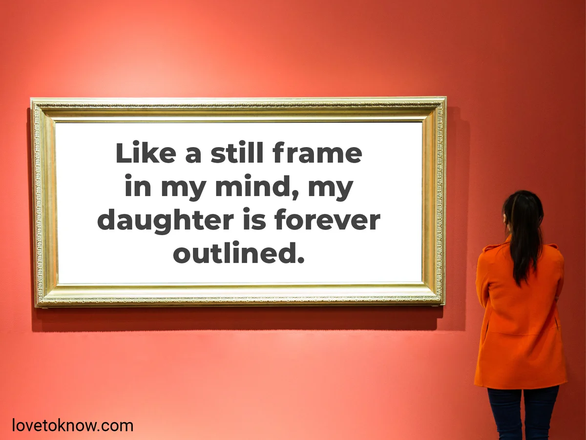 Woman looking at an empty frame on a red wall