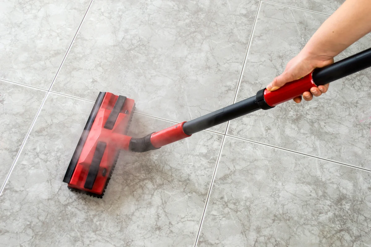 Woman cleaning floor steam cleaning