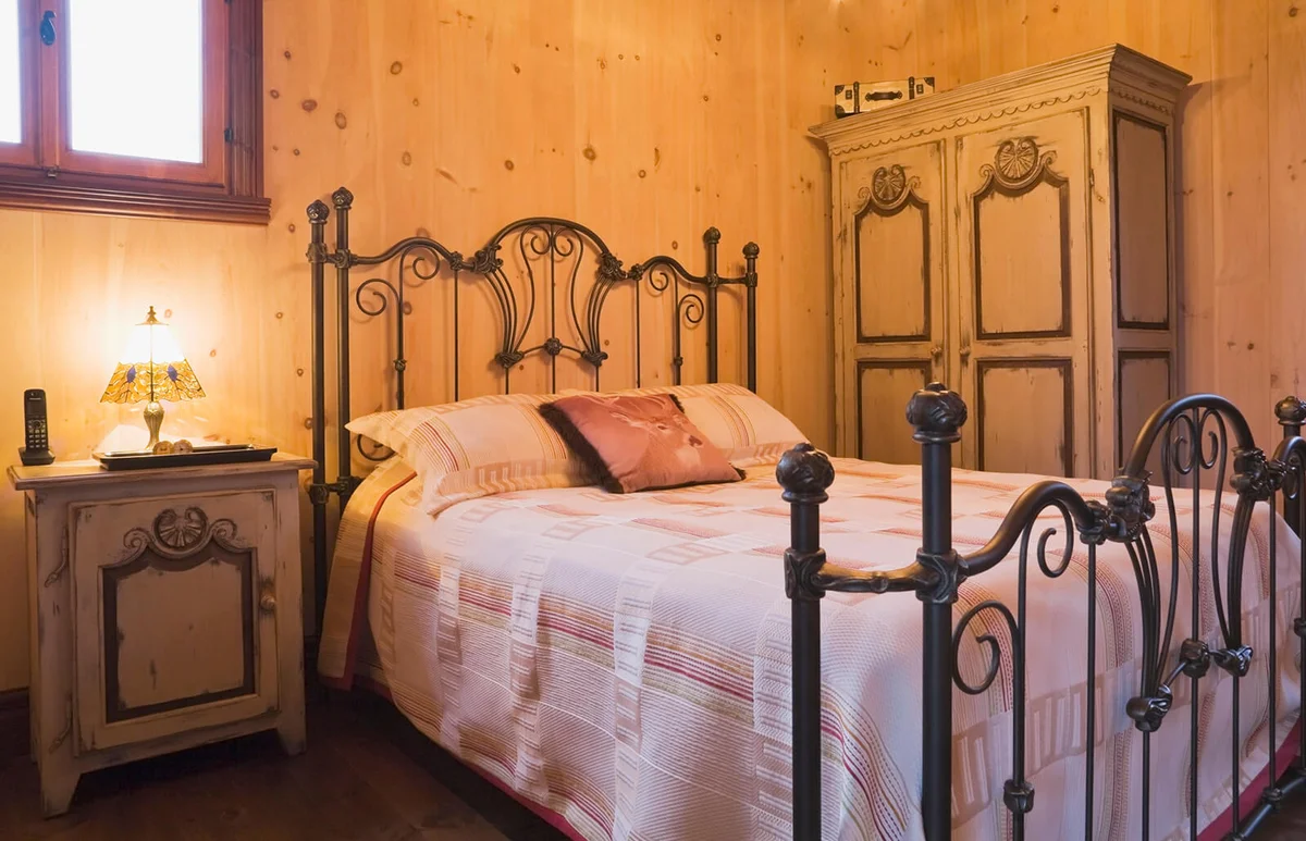 Double bed with wrought iron headboard and footboard