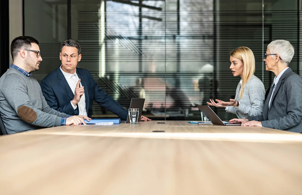Young couple and their lawyers taking about separation in the office