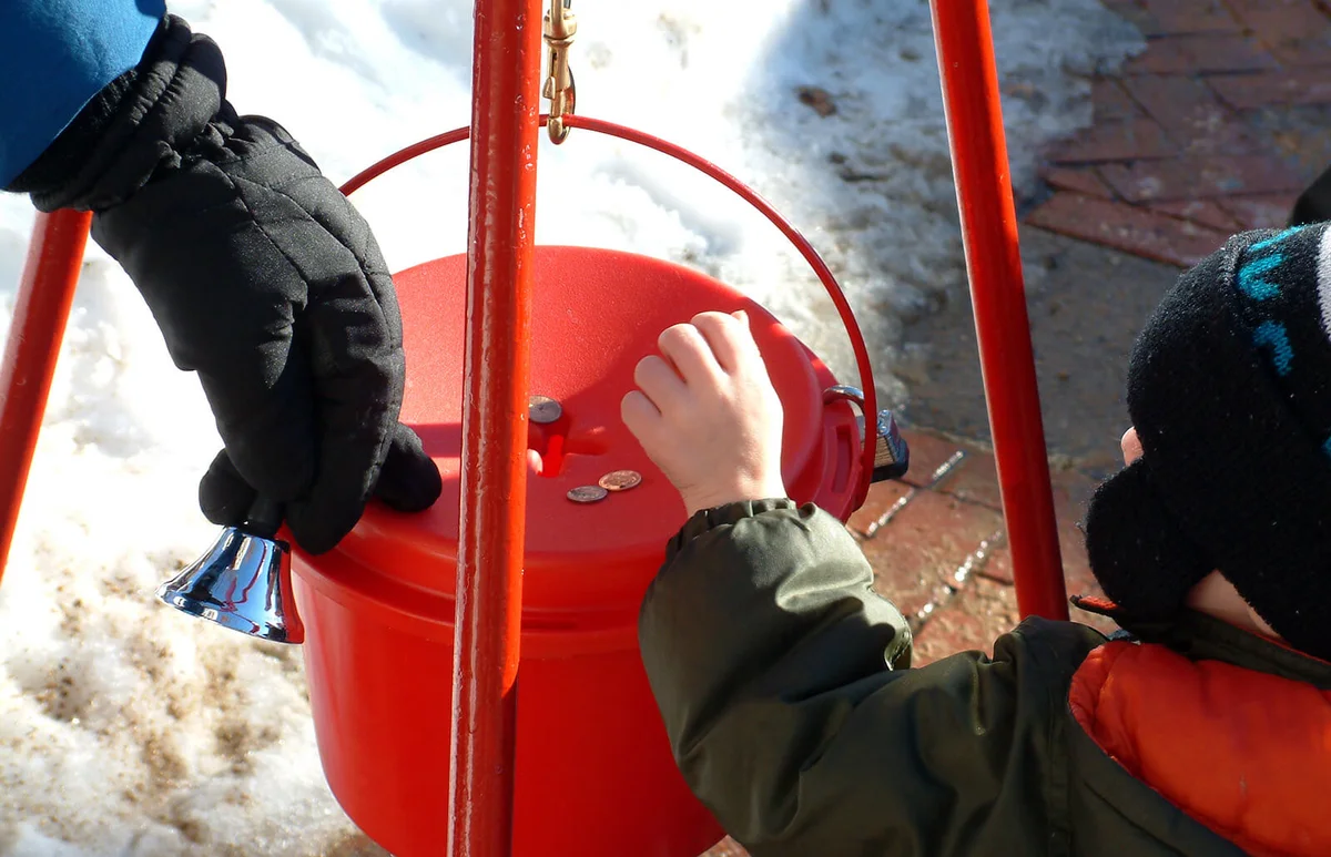Boy donates coins during holiday season