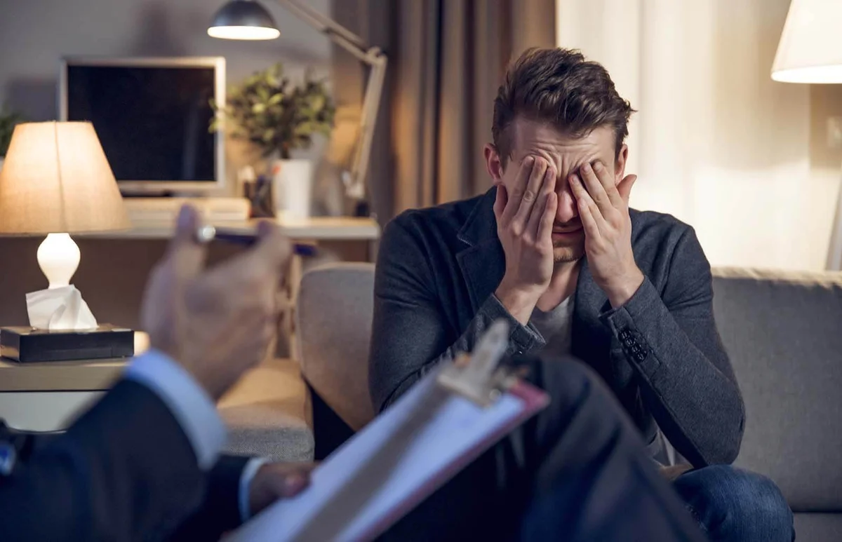 psychologist interviewing his depressed patient