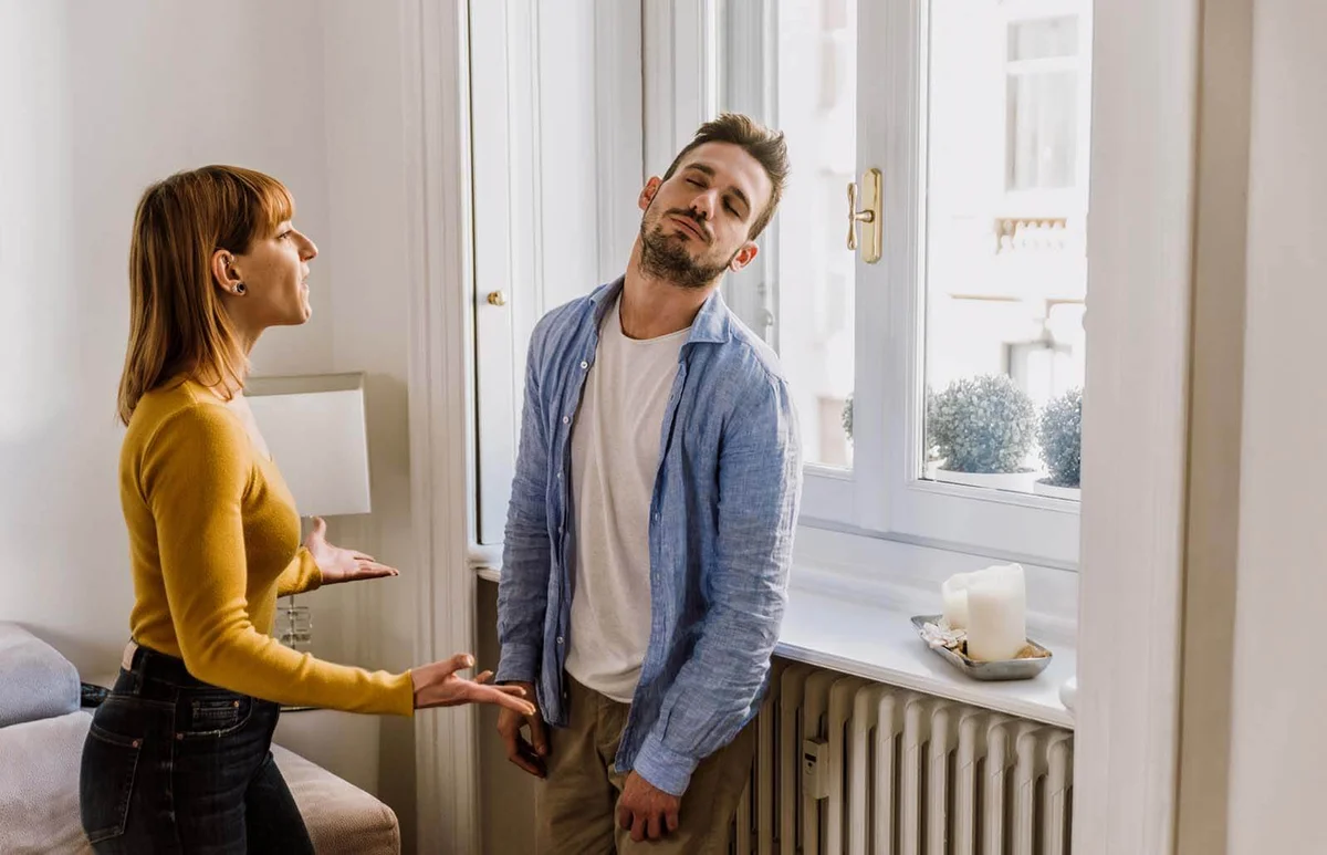 Young Couple Arguing While Standing At Home
