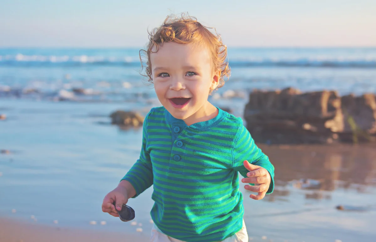 Toddler running on the beach
