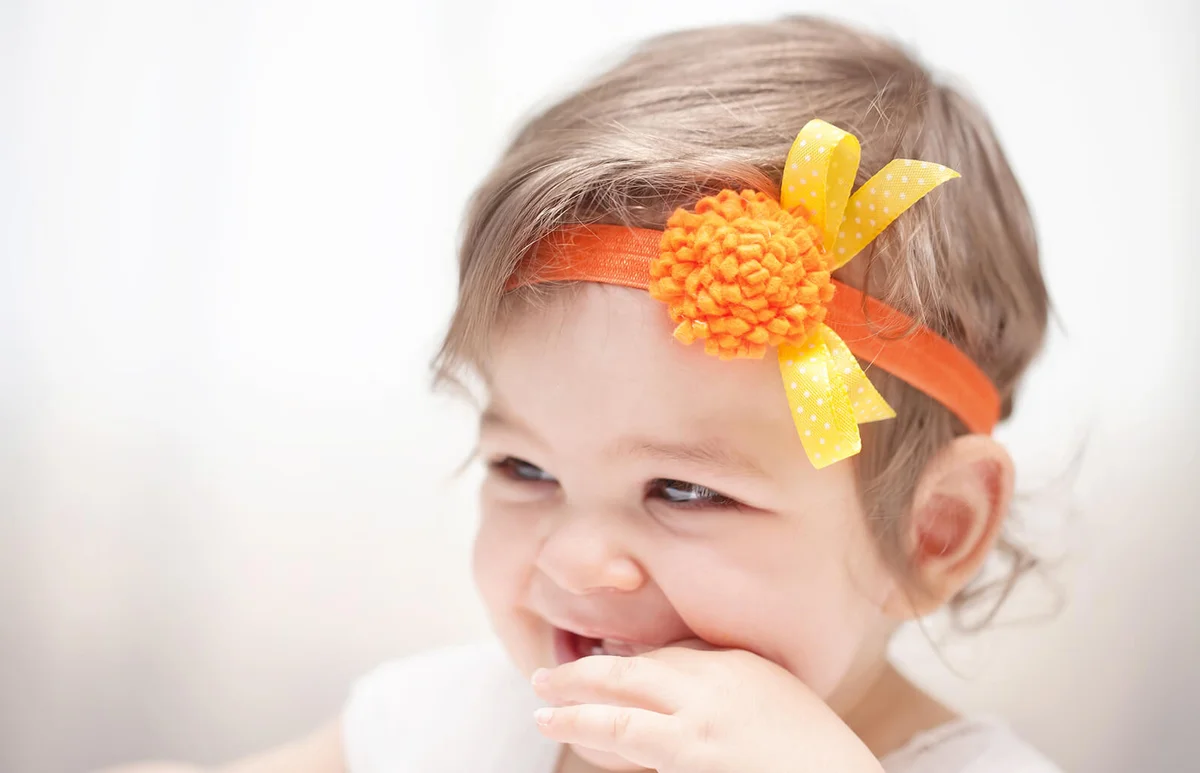 Cute smiling babygirl looking away