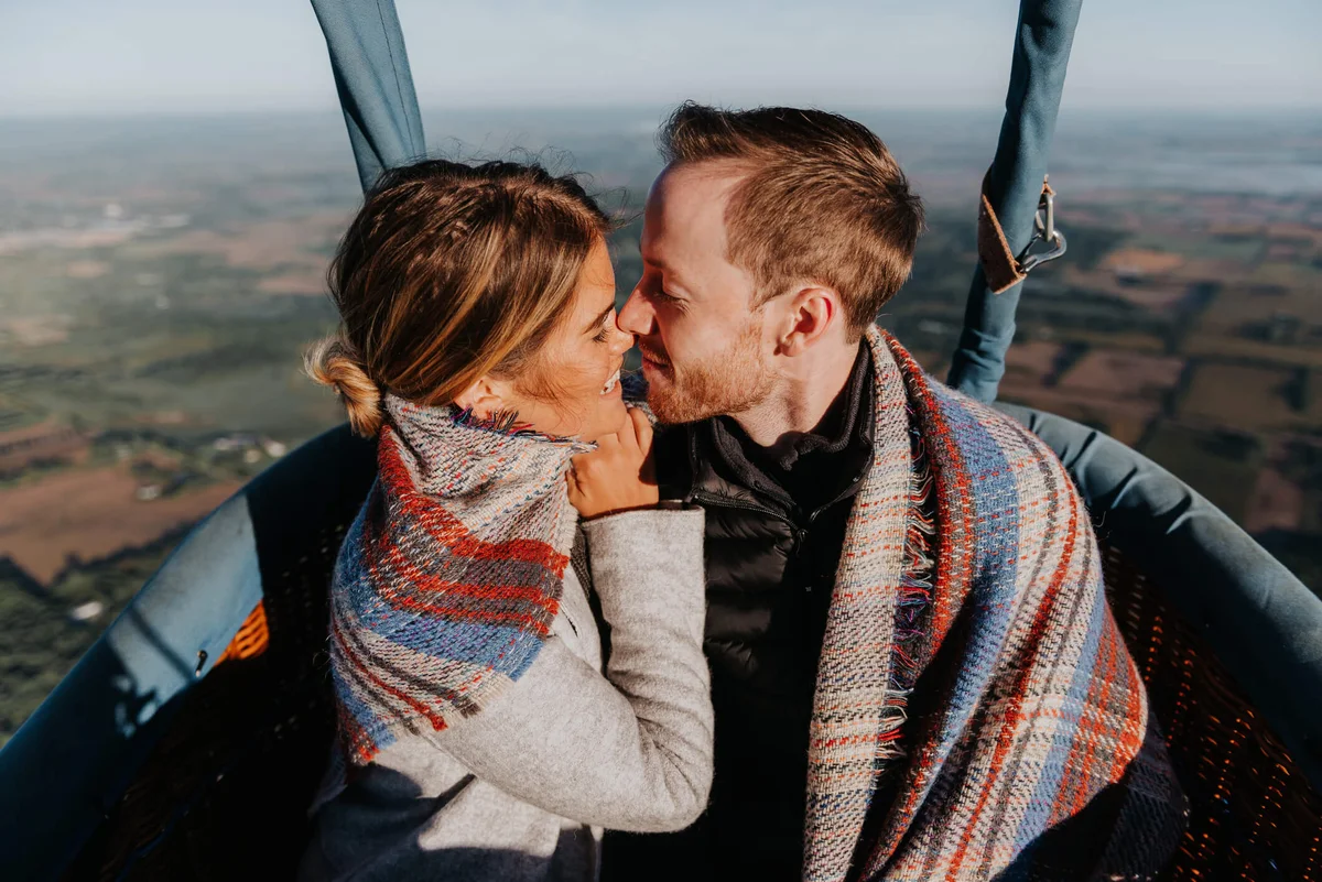 Newly engaged couple in hot air balloon