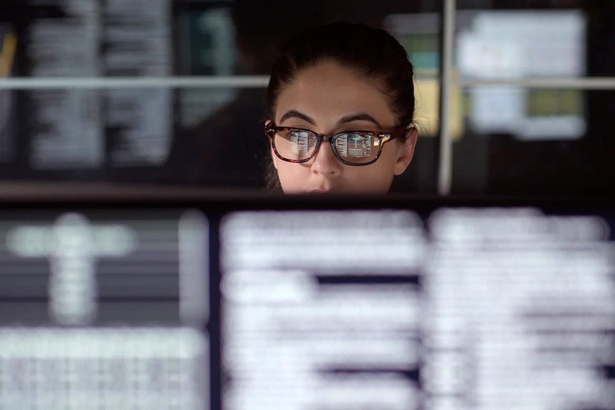 Data woman surrounded by monitors
