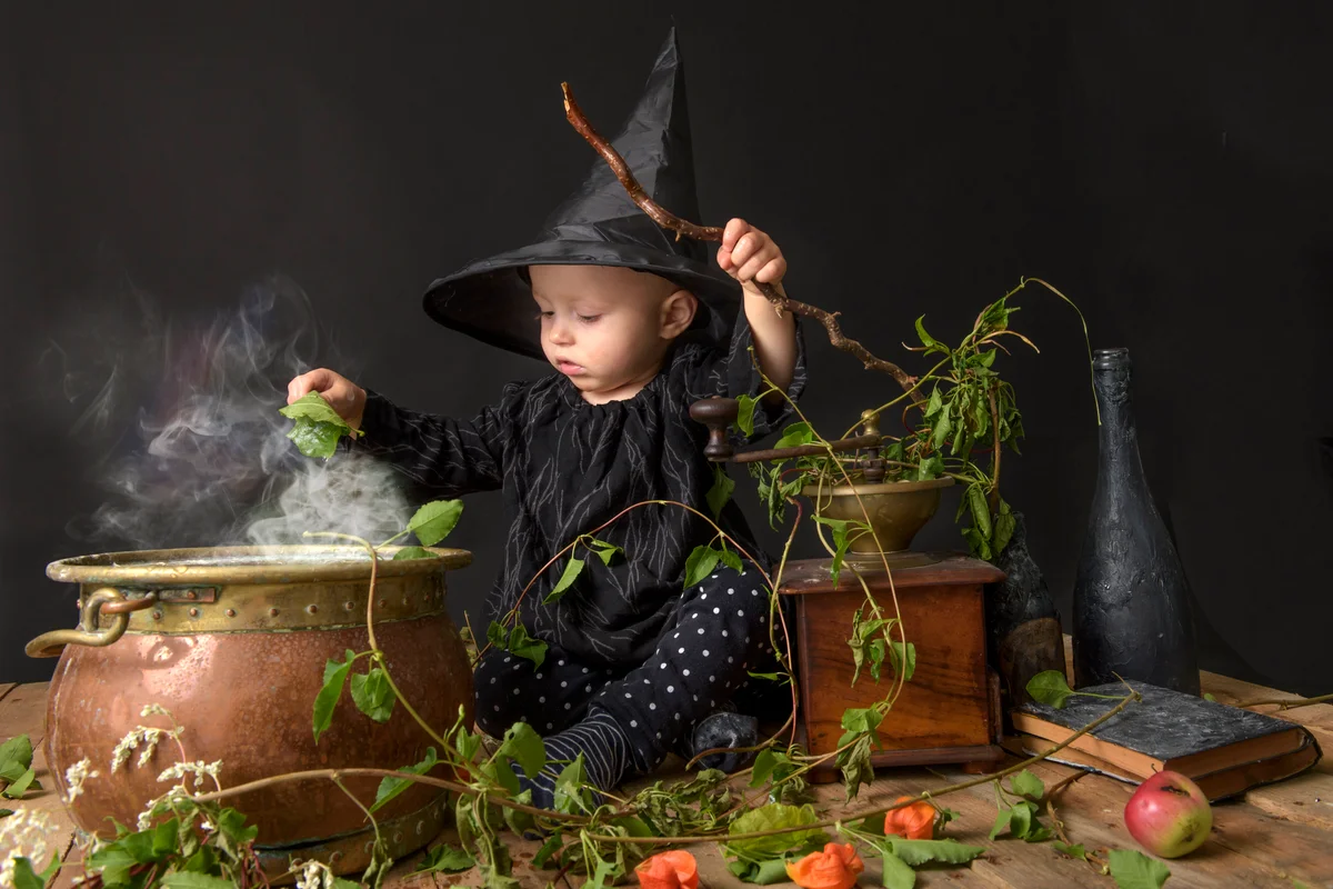 Little baby witch cooking a potion