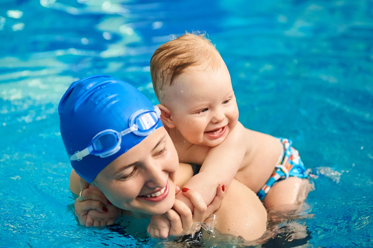 Child having fun in water with mom