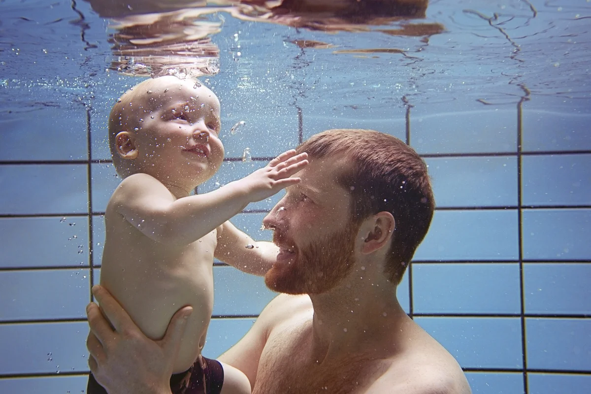 Father and son swimming together underwater