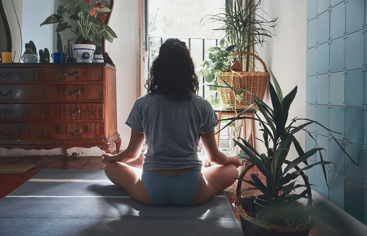 Woman Meditating While Sitting At Home