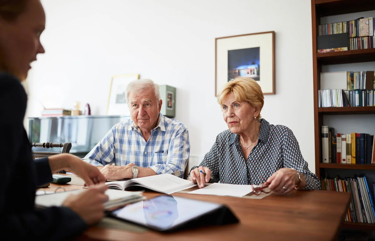Senior couple meeting with financial consultant at home