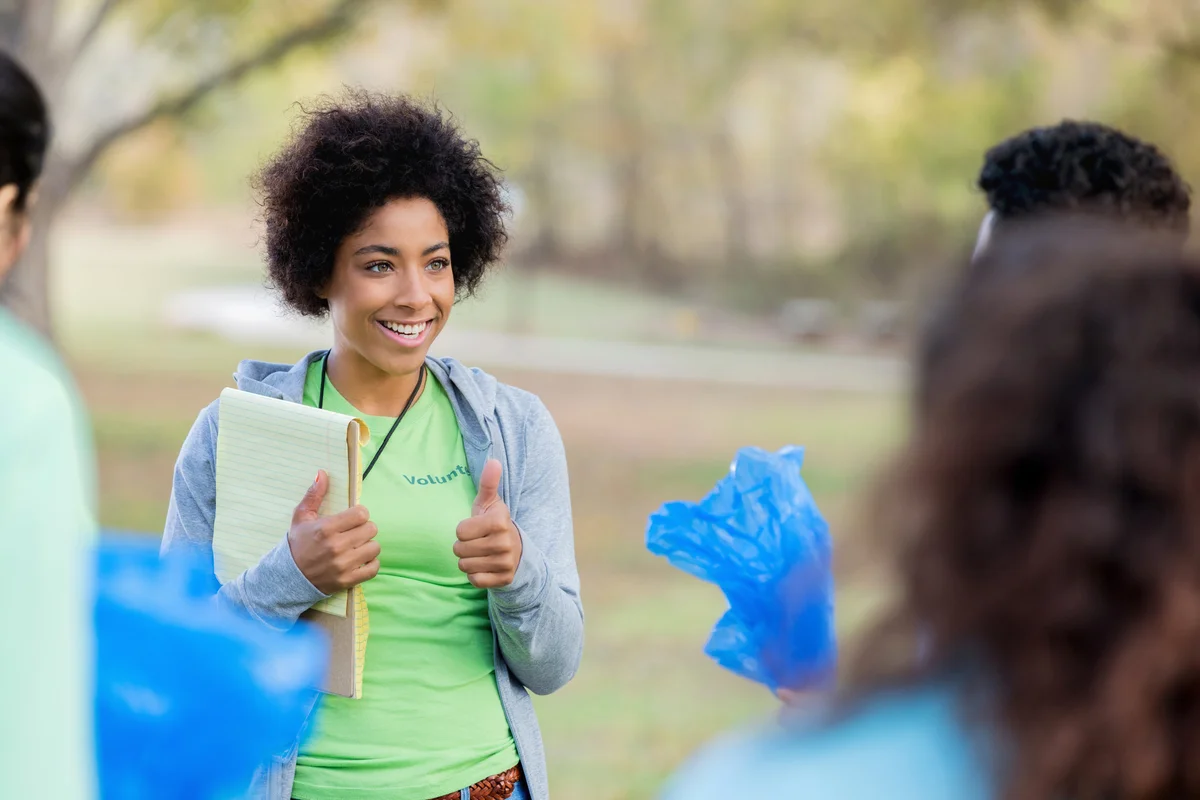 Young woman organizes community cleanup volunteers