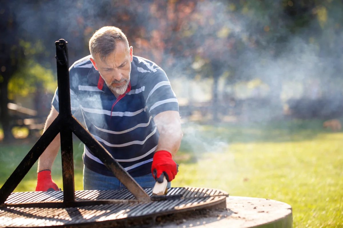 Man cleaning the barbecue grill
