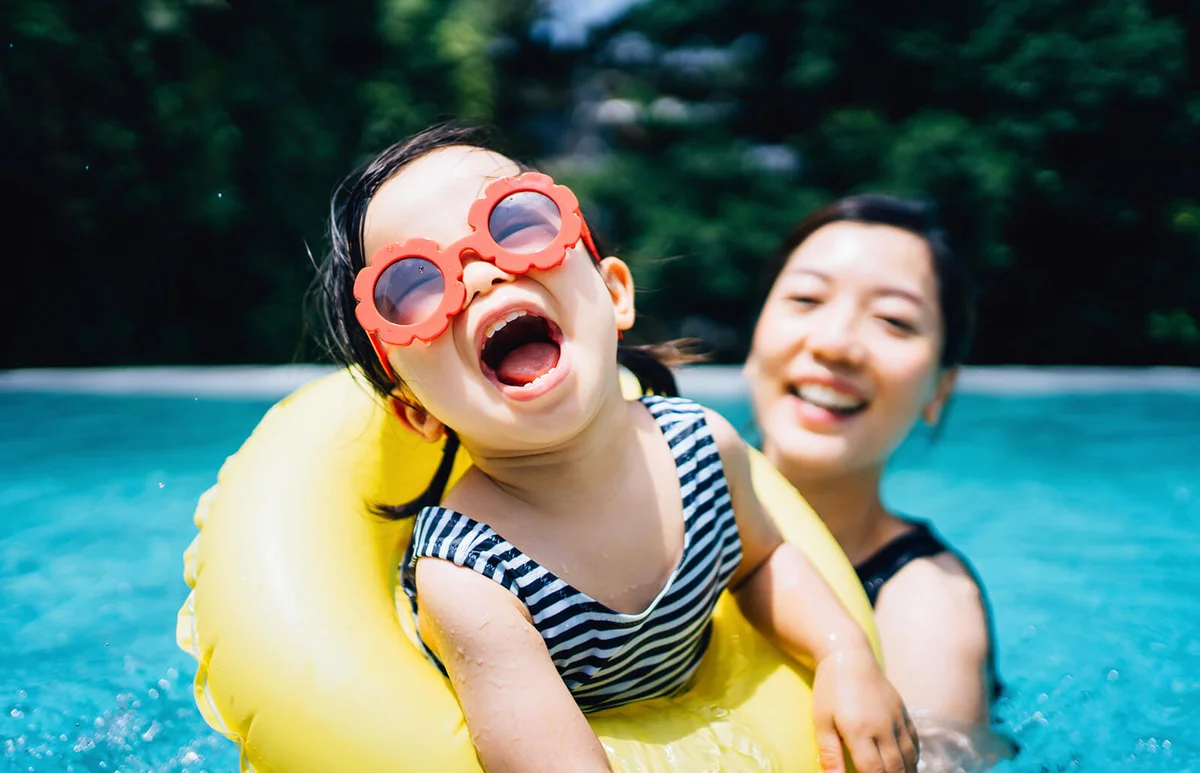 Happy toddler girl with sunglasses smiling joyfully