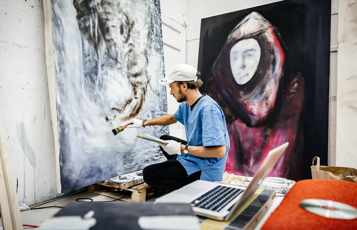 Young Artist working on big painting